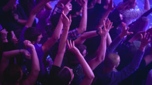 Crowd at a concert with their hands up